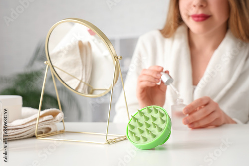 Obraz na płótnie Hair scalp massager of table of woman with serum at home, closeup