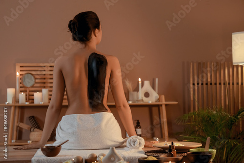 Young woman with mud sittin...