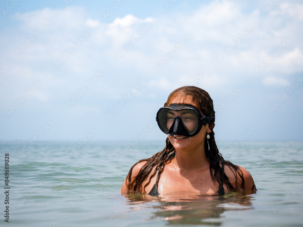 Naklejka premium Woman Snorkeling in Clear Ocean Water on a Sunny Day