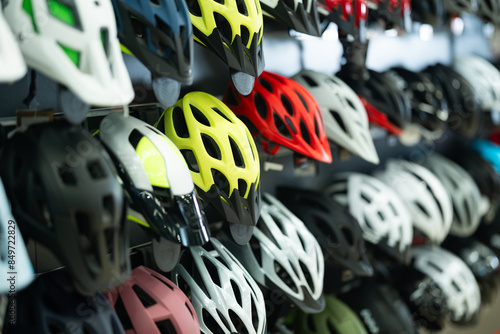 Foto Variety of bicycle helmets in different colors and designs neatly displayed on s