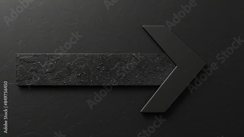 A textured dark arrow sign implying direction, choice, or progress on a dark textured background photo