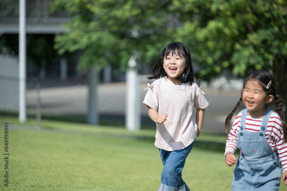 Smiling children (toddlers) running on the lawn Parks, daycare centers, and kindergartens Copy space available on the left Smiling children (toddlers) running on the lawn Parks, daycare centers, and kindergartens Copy space available on the left