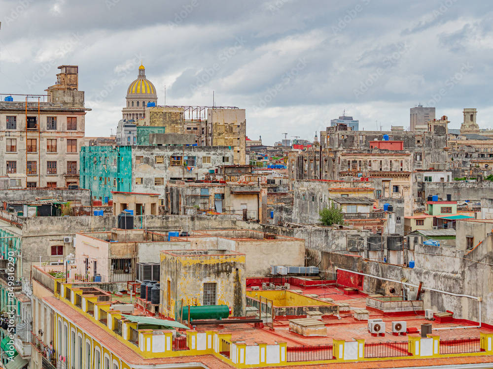 Fototapeta premium Havana from the above. View over the rooftops of Havana in Cuba with the Capitol. Rooftops of Old Havana, Cuba on a cloudy day. View of rooftops of old houses