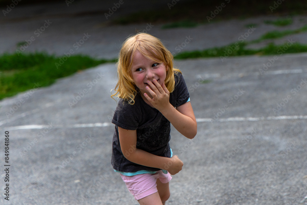 little girl squealed with joy as she tossed the pink ball high into the air. little girl squealed with joy as she tossed the pink ball high into the air.