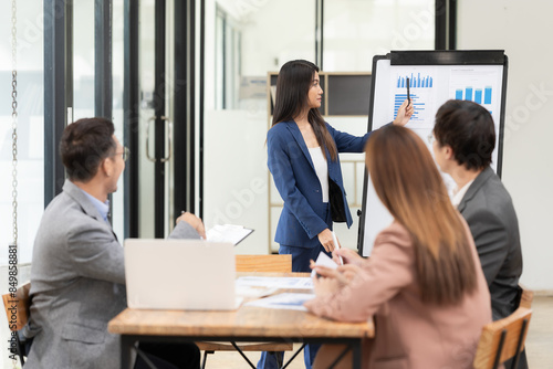A team of Asian businessmen meets on a company budget to analyze and discuss the financial report situation in the conference room. investment consultant financial advisor