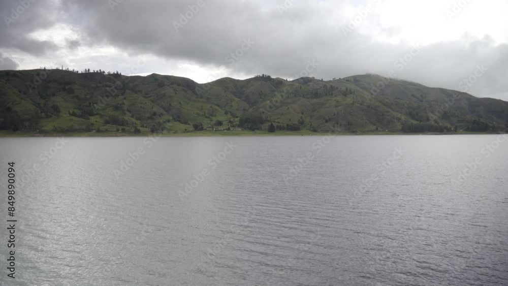 Morning fog over a beautiful lake surrounded by pine forest , lake Corani Bolivia Morning fog over a beautiful lake surrounded by pine forest , lake Corani Bolivia