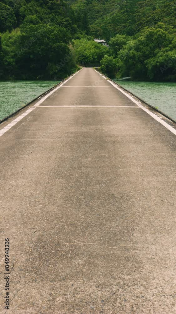 Beautiful view of a submerged bridge on the river in the forest, Shimanto River in Kochi Prefecture in Japan, Travel or outdoor, Nobody, Vertical video for smartphone footage Beautiful view of a submerged bridge on the river in the forest, Shimanto River in Kochi Prefecture in Japan, Travel or outdoor, Nobody, Vertical video for smartphone footage
