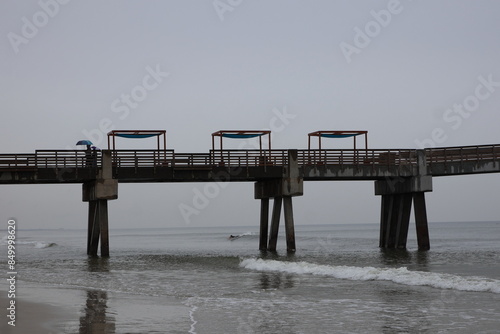 Boardwalk and pier on the beach across the ocean mid-morning. Jacksonville, Florida.