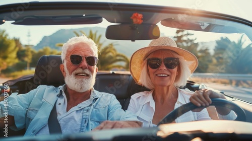 elderly cheerful Caucasian people in sunglasses travel in their car, a pensioner woman driving a car © Photolife  