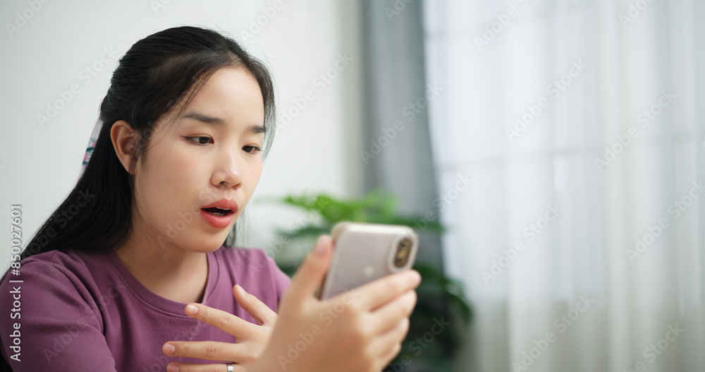 Portrait of Young asian business woman using smartphone for video conference call presenting project plan to colleagues at home office, online meeting for remote work Portrait of Young asian business woman using smartphone for video conference call presenting project plan to colleagues at home office, online meeting for remote work
