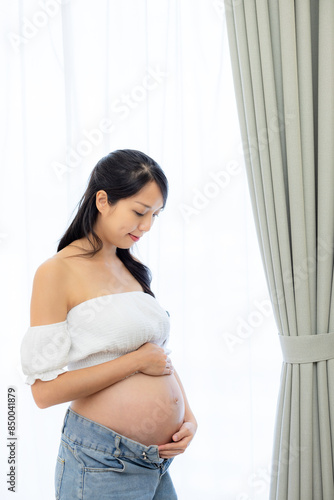 Pregnant woman look at her tummy at home Free Download Pregnant woman look at her tummy at home - GFXLoad