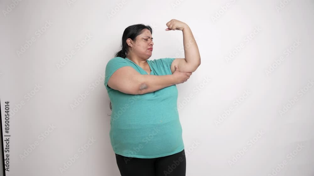 Overweight indian woman check her excessive fat on her arm, Weight loss, obesity and health care concept. 4k Overweight indian woman check her excessive fat on her arm, Weight loss, obesity and health care concept. 4k
