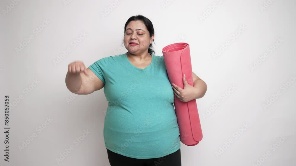 Happy Overweight indian woman holding yoga mat and doing thumbs up isolated over white background. Fitness lifestyle 4k Happy Overweight indian woman holding yoga mat and doing thumbs up isolated over white background. Fitness lifestyle 4k
