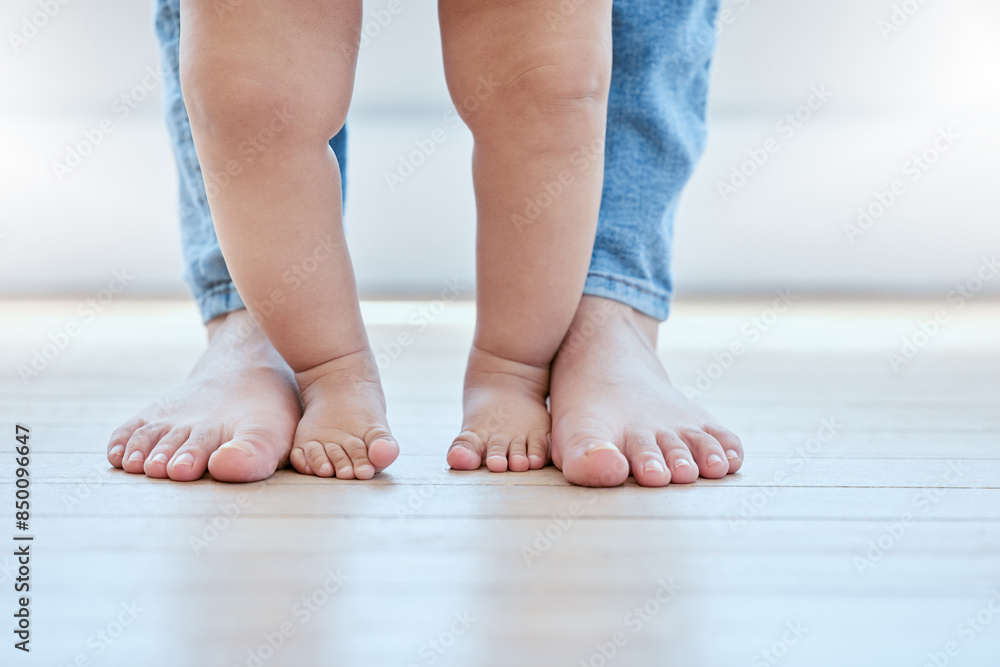 Baby, walking and feet in lounge with person for growth, development and support for childhood. First steps, legs and together in home for learning, teaching and mother for exercise or balance Baby, walking and feet in lounge with person for growth, development and support for childhood. First steps, legs and together in home for learning, teaching and mother for exercise or balance