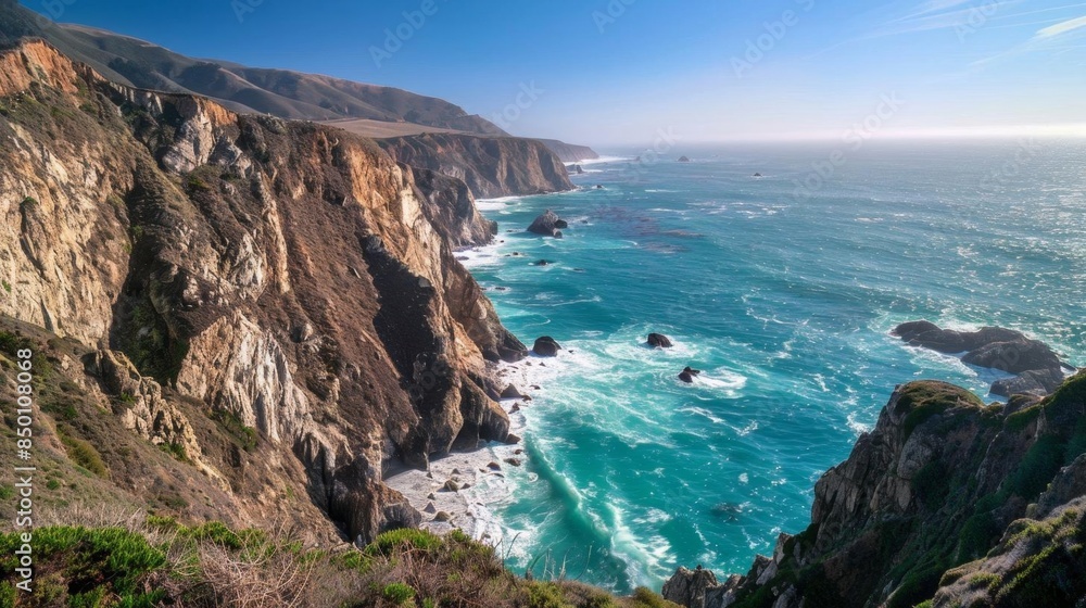 A dramatic coastline with towering cliffs and waves crashing against the rocks A dramatic coastline with towering cliffs and waves crashing against the rocks
