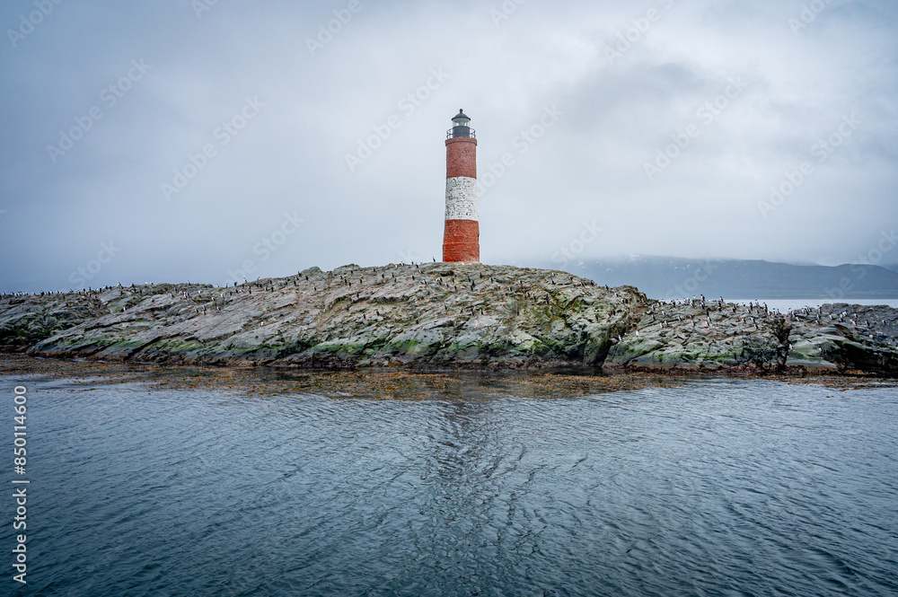 Lighthouse end of world, Canal Beagle, Ushuaia, Argentina with penguins and sea Lighthouse end of world, Canal Beagle, Ushuaia, Argentina with penguins and sea