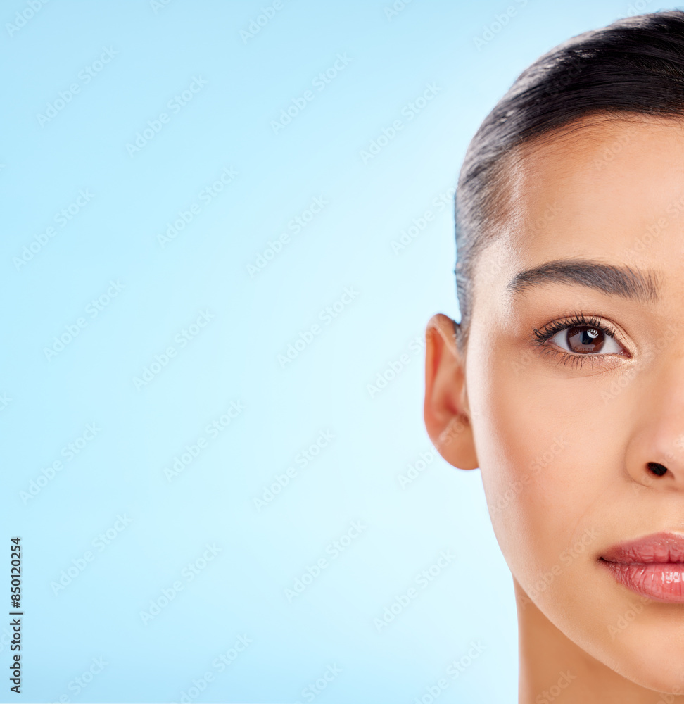 Half face, woman and skincare in studio for beauty and aesthetics for mockup space. Model girl, cosmetics portrait and dermatology, wellness or collagen for fine lines and glow by blue background Half face, woman and skincare in studio for beauty and aesthetics for mockup space. Model girl, cosmetics portrait and dermatology, wellness or collagen for fine lines and glow by blue background
