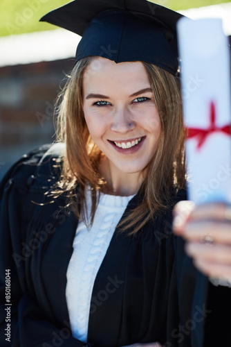 Graduation, woman and portrait for degree, education and outdoor with smile and happiness for goal. Achievement, person and student in college, event and celebration for learning and graduate