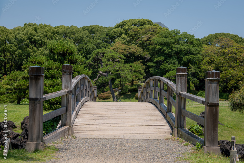A bridge with an old architectural style surrounded by beautiful trees in Japan A bridge with an old architectural style surrounded by beautiful trees in Japan