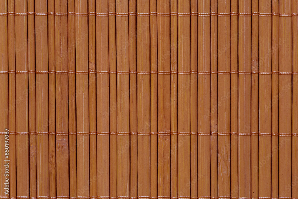 close up of mat made of brown bamboo sticks close up of mat made of brown bamboo sticks