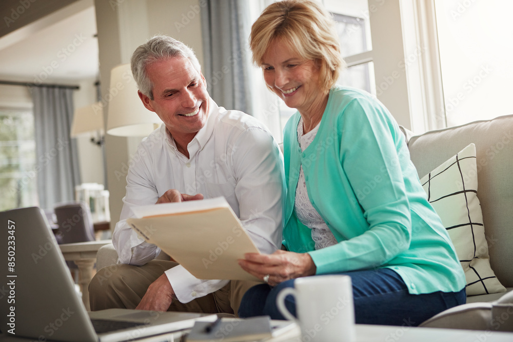 Senior couple, paperwork and laptop on sofa with discussion, smile and taxes in home. Old man, woman and computer with documents for compliance, reading and investment report with finance management Senior couple, paperwork and laptop on sofa with discussion, smile and taxes in home. Old man, woman and computer with documents for compliance, reading and investment report with finance management