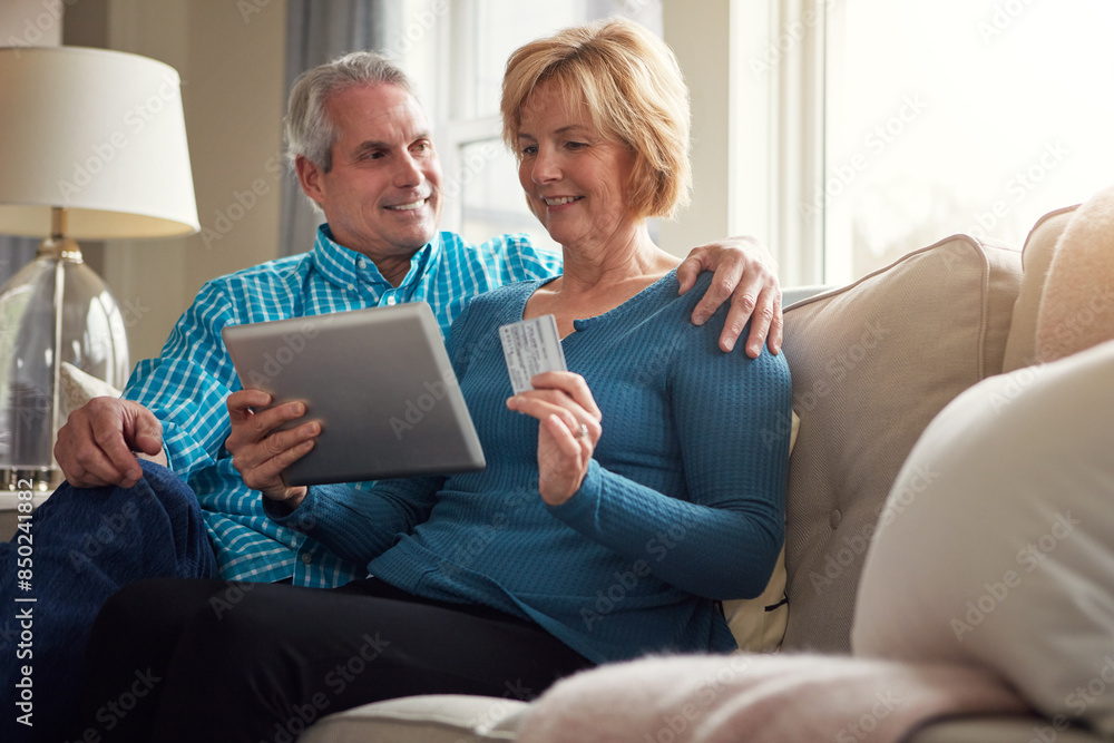Senior couple, tablet and credit card on sofa for e commerce, decision and sale on web in home living room. Old man, woman and fintech app for banking with deal, discount and smile on couch in house Senior couple, tablet and credit card on sofa for e commerce, decision and sale on web in home living room. Old man, woman and fintech app for banking with deal, discount and smile on couch in house