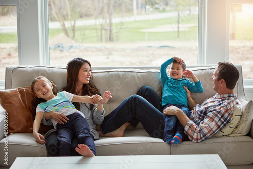 Relax, children and happy family in house with parents together for care, love or bonding. Kids, mother and father on sofa for support, talking or playing with funny siblings laughing in living room