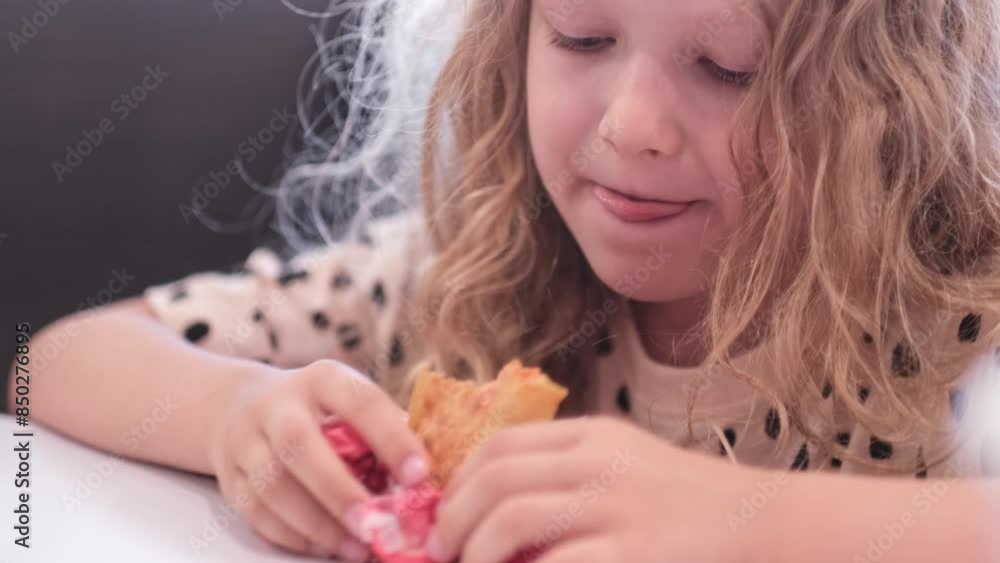 Girl eats fries chiken indoor caffe interior . kid puts food in his mouth and chews. Portrait blond Caucasian curly cute girl sitting at table in fast food restaurant and eating food. 4k Girl eats fries chiken indoor caffe interior . kid puts food in his mouth and chews. Portrait blond Caucasian curly cute girl sitting at table in fast food restaurant and eating food. 4k