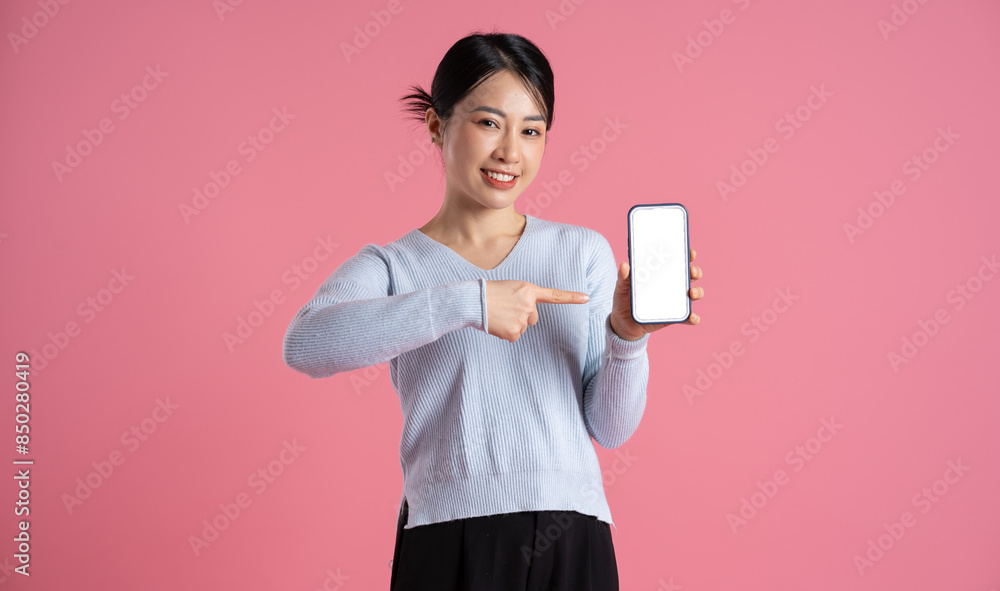 Portrait of beautiful asian woman posing on pink background Portrait of beautiful asian woman posing on pink background