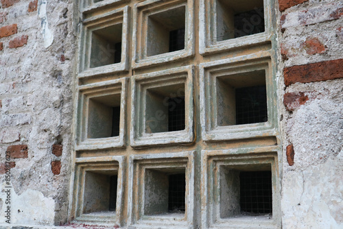 White stone Roster texture or ventilation block made from cement concrete and used as a house wall with brick texture on the side. square shape.