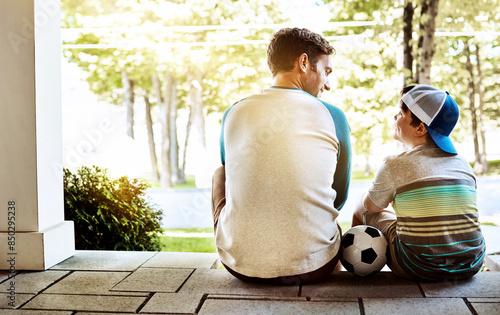 Love, back or father and son with soccer ball on front porch for conversation, advice or bonding. Family, safety or man with kid outdoor for football, help or talking with care, trust for security