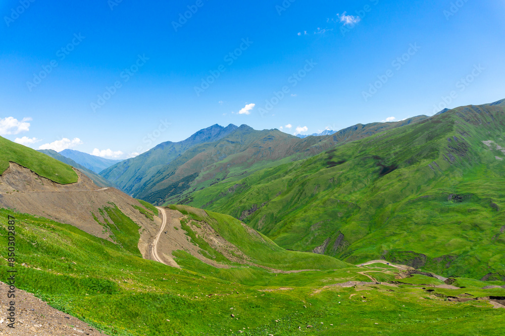Obraz premium Mountain road leading to the Datvisjvari pass. Mountains covered with green vegetation