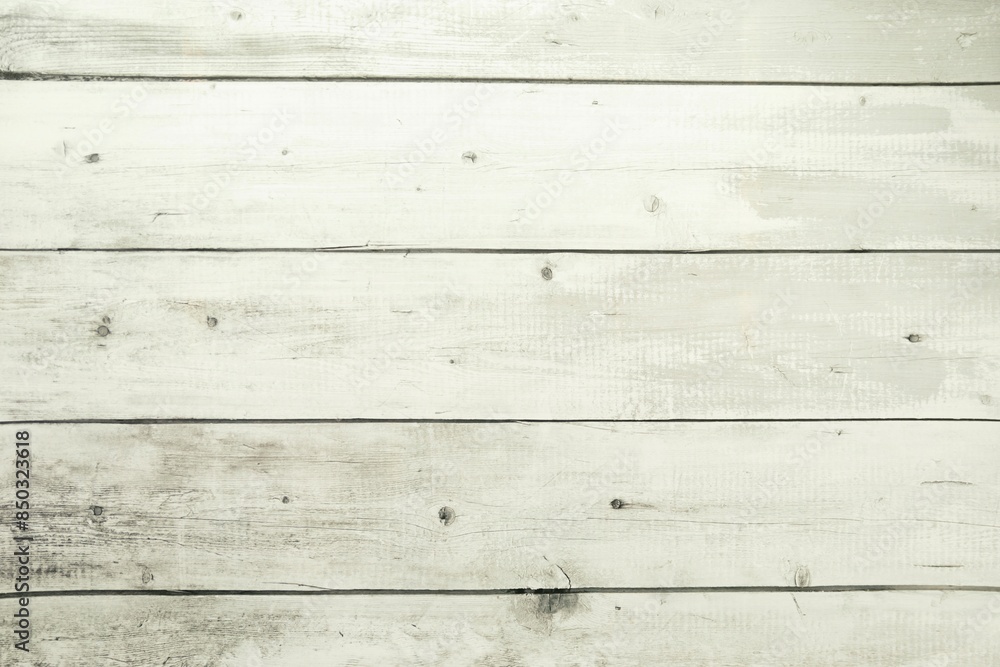 Naklejka premium A closeup of a wooden floor with planks. The wood looks aged and weathered and has various shades of brown and natural grains. The surface has a slightly rough texture with visible lines and spots.