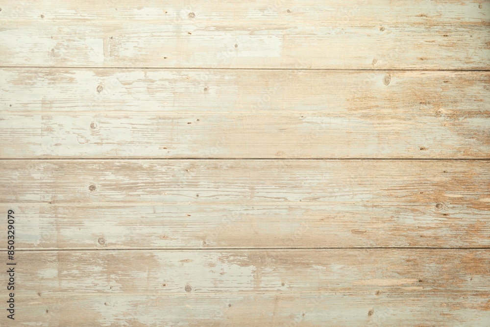 A closeup of a wooden floor with planks. The wood looks aged and weathered and has various shades of brown and natural grains. The surface has a slightly rough texture with visible lines and spots.