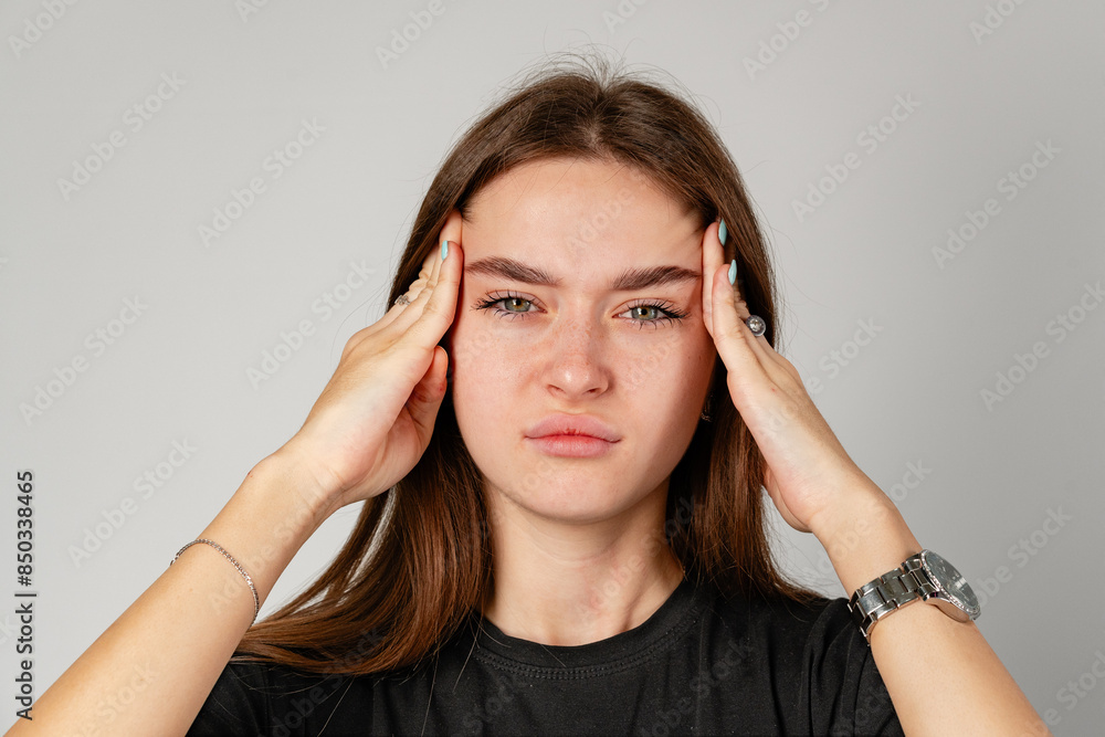 Young Woman Holding Head in Hands because of headache Young Woman Holding Head in Hands because of headache
