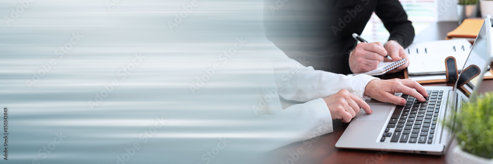 Two business people working together; panoramic banner Two business people working together; panoramic banner
