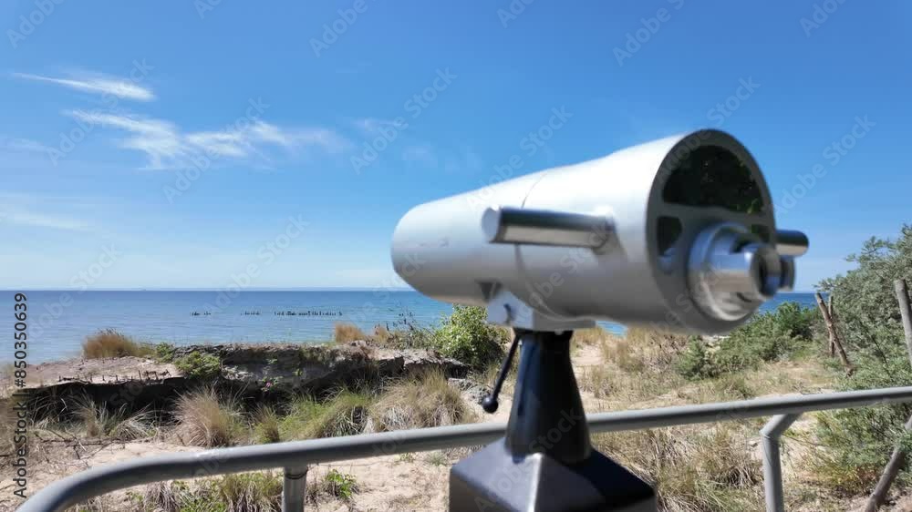 Binoculars on the beach to observe the Baltic Sea. Panorama view.