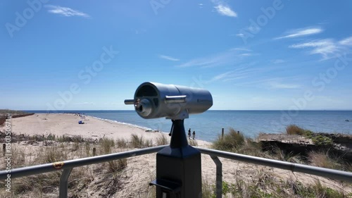 Viewpoint with binoculars by the beach in Hel city. Slow motion video. photo