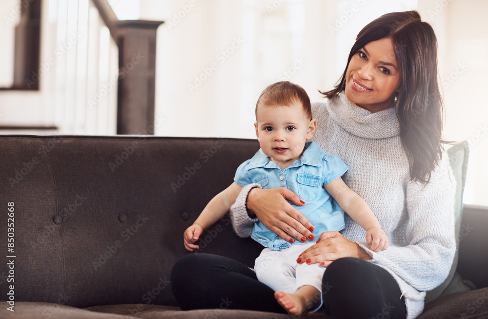 Portrait, baby and mother on sofa in living room, holding hands for love and bonding for support. Smile, motherhood and toddler with woman together, hug and play by sitting for relationship at home Portrait, baby and mother on sofa in living room, holding hands for love and bonding for support. Smile, motherhood and toddler with woman together, hug and play by sitting for relationship at home