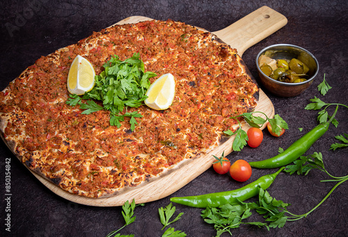 Lahm bi ajeen pizza bread served in wooden board isolated on background top view of Arabic Manaqeesh photo