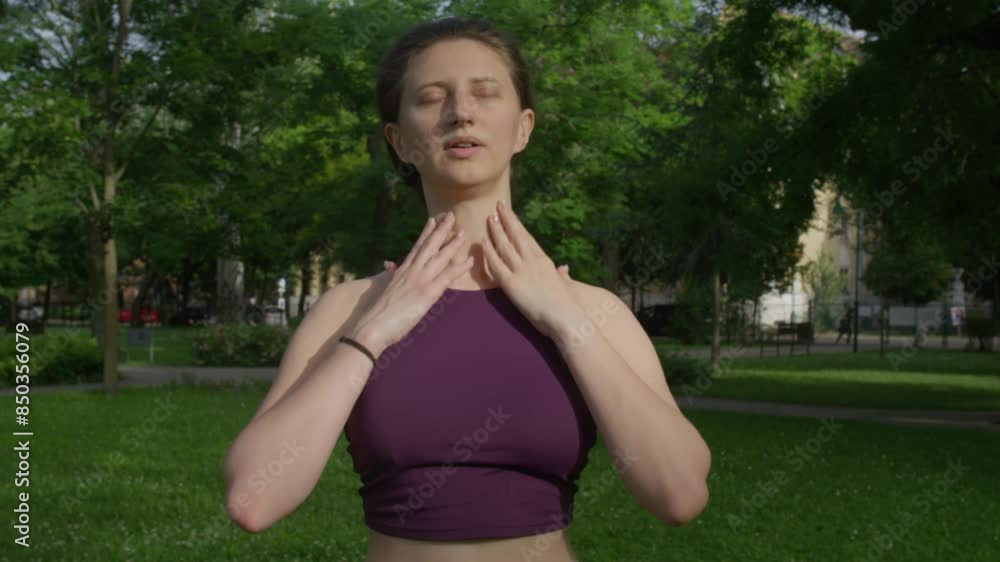 Young beautiful woman warming up her neck with side to side movements Young beautiful woman warming up her neck with side to side movements
