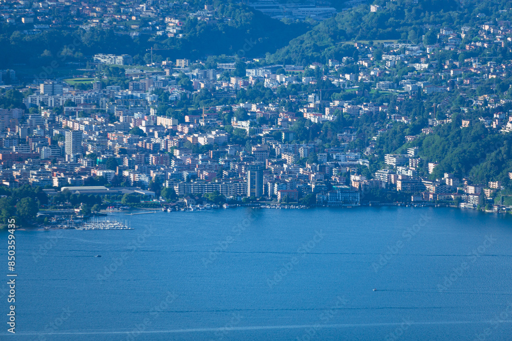 Obraz premium The mountains and the landscape of lake Lugano, during a spring day, near the town of Brusino Arsizio, Switzerland - May 25, 2024.