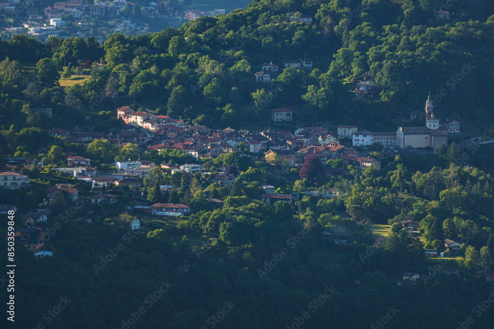 Fototapeta premium The mountains and the landscape of lake Lugano, during a spring day, near the town of Brusino Arsizio, Switzerland - May 25, 2024.