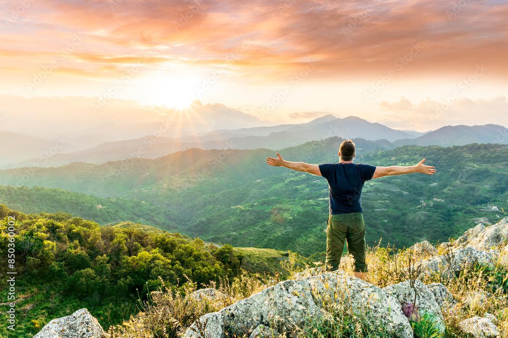 Obraz premium happy man watching amazing highland evening sunset, person delight with nature landscape