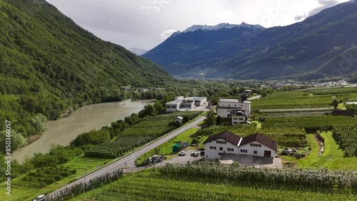 Vista con drone della Valtellina, del fiume Adda e del paese di Sernio e le montagne con il passo del Mortirolo photo