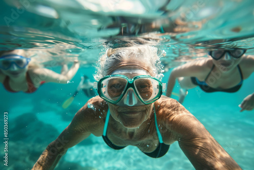 Mature woman swims in an open pool underwater  © Ivan