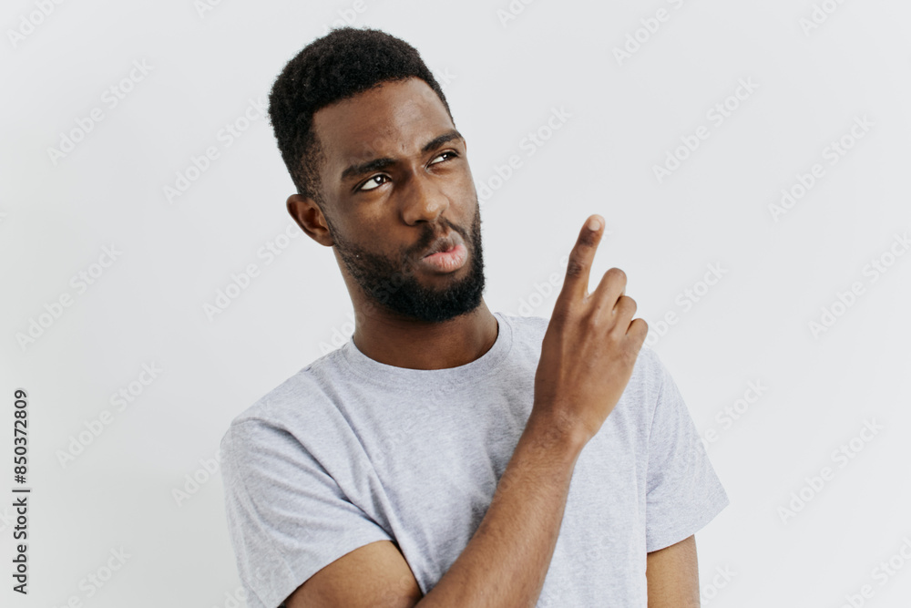 Confident african american man with beard gesturing to the side while making eye contact Confident african american man with beard gesturing to the side while making eye contact