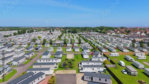 Sweeping aerial views of the seaside town of Skegness on the Lincolnshire Coast of England. Showing holiday homes and static caravans in rows on popular tourist camp sites. Tourist accommodation