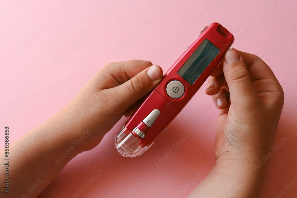 Fototapeta premium Close-up Of Woman Hands Testing High Blood Sugar With Glucometer