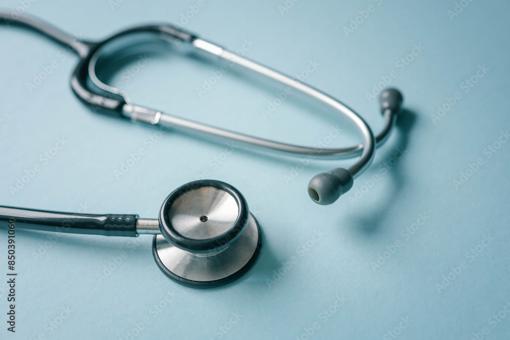 Stethoscope on blue background, top view. Space for text Stethoscope on blue background, top view. Space for text